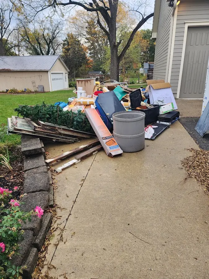 Dumpster being loaded with debris for 12 Yard Dumpster Rental in Eastvale